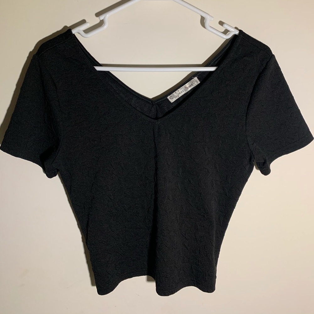 Black v-neck style shirt with embroidered hearts